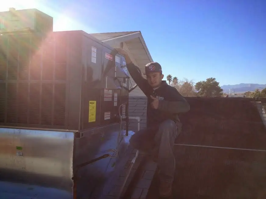 HVAC technician performing HVAC Inspection on a rooftop unit in Santa Paula